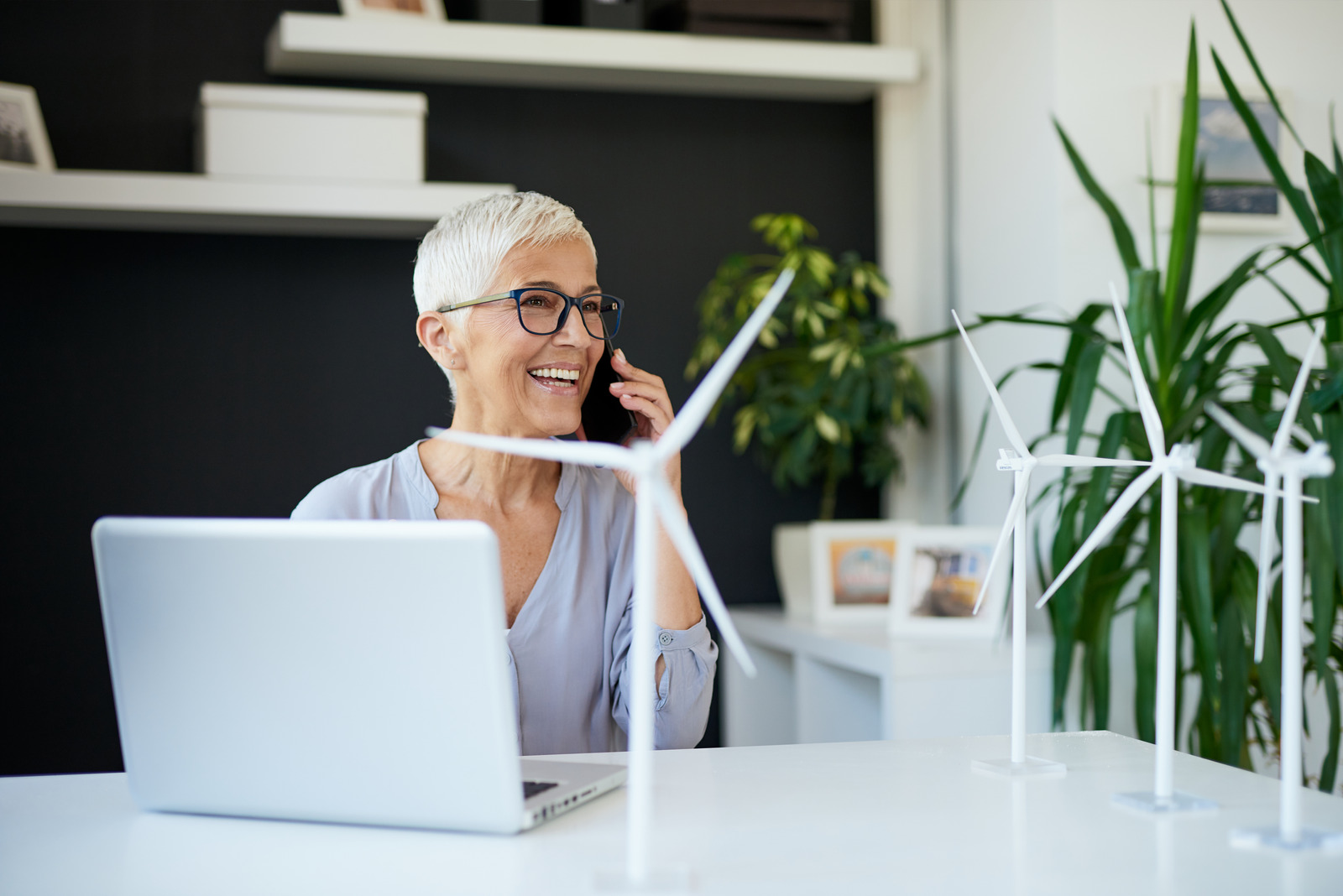 happy laptop customer smiling on the phone with a laptop